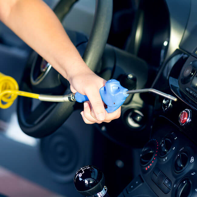 Air gun cleaning interior of car