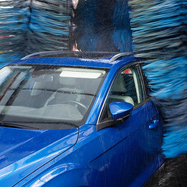 Car being washed in a car wash tunnel